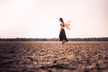 woman with wings in a field